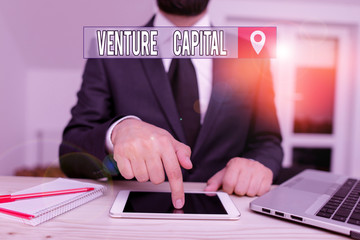 Conceptual hand writing showing Venture Capital. Concept meaning capital invested in a project in which there is risk Male human wear formal clothes present use hitech smartphone