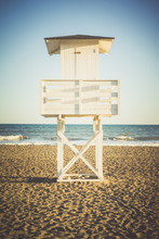 View On Wooden White Lifeguard Tower On Beach In Sunlight