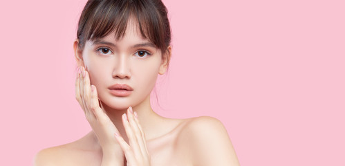 beautiful young asian korean woman with clean fresh skin touching her own face. face treatment. cosm
