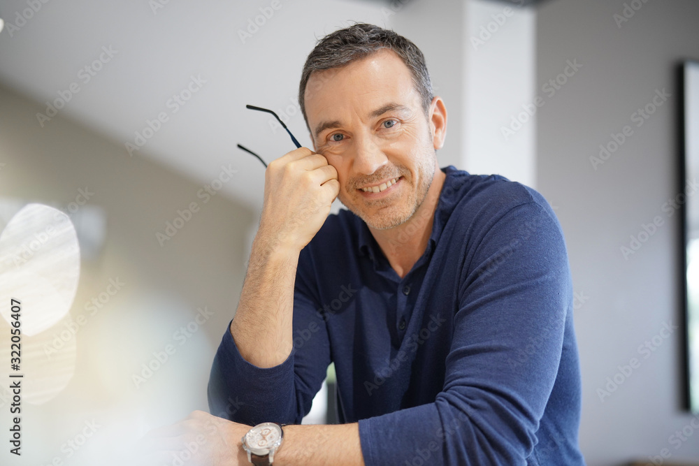 Portrait of middle-aged man with blue shirt - obrazy, fototapety, plakaty 