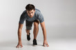 © Drobot Dean - Confident young sportsman standing ready to start running