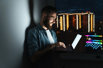 Poster - Confident young man working on laptop computer