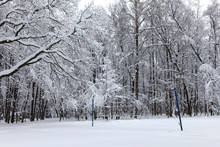 Volleyball Court Covered With Snow After Winter Snowfall. Beautiful Landscape Of February Park With A Sports Field, Snowy Trees Snowdrifts Background. Black White Monochrome Photo.