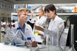 © JackF - Modern Caucasian and Asian students at lab