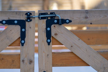 Wooden Gate Closed On A Metal Latch With A Spring