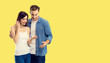 © vgstudio - Love, new parents and happy family concept - young happy couple, finding out results of a pregnancy test. Yellow color background. Copy space for some text.