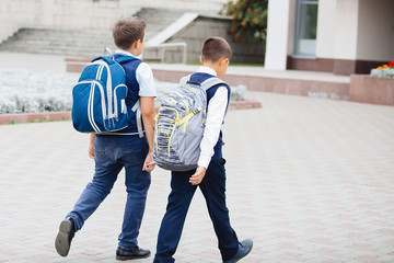 Wall Mural - Children with backpacks go to school.