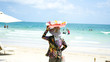 © Hryhorii - A woman sells fruit on the beach in an exotic location.