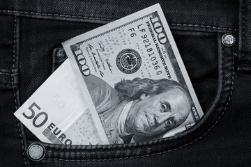 One hundred dollar banknote money in pocket jeans pants background texture. 100 dollar bill close up