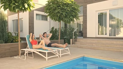 Poster - A calm relax couple man and woman are resting in the terrace near the swimming pool in summer