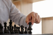 © Orathai - hand of businessman moving chess in competition, shows leadership, followers and business success strategies
