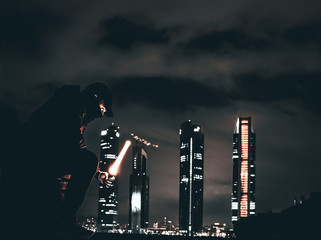 night photographs of buildings in Madrid with young man covered in black