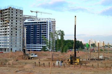 Poster - Piles driven into the ground by hydraulic hammer. Working at construction of a new metro line. Digding the tunnel subway and railway station platform deep underground. Ground drilling machine