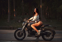 Sexy Fit Woman With A Black Motorcycle In Cafe Racer Style