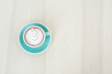 One coffee cup of hot black cappuccino on clean wooden table top view in warm morning light. Hot espresso in ceramics mug on empty rustic brown wood color concept for Aroma love caffeine taste smell.