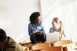 © BalanceFormCreative - Two female students chatting and taking a break between college classes.
