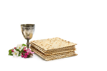 Matzo, wine and pink flowers apple tree for passover celebration on white background with space for text