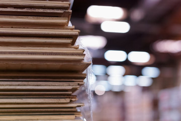 Wall Mural - Timber Flooring Factory. Pile of cut wood in factory storage warehouse. Lumber in warehouse.