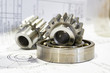 © andov - Gear and bearing lie on the technical drawing, concept of gear cutting production.