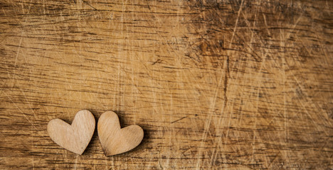 Wall Mural - Two wooden hearts placed nicely on vintage wood background