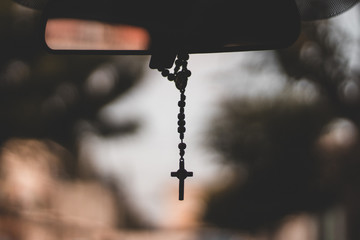 focus rosary beads with bokeh ligths in car 