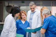 © Halfpoint - Group of doctors talking about corona virus on conference.