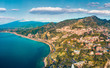 View from flying drone. Marvelous morning view of Taormina town and Etna volcano on background. Incredible spring seascape of Mediterranean sea. Splendid view of Sicily, Italy, Europe.