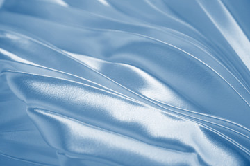 classic blue luxury satin fabric folds background. rippled blue silk fabric satin cloth gathers glam