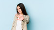 © Asier - Young caucasian woman isolated on blue background rejecting someone showing a gesture of disgust.