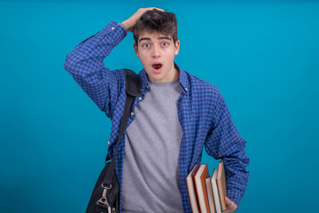 Wall Mural - teen student boy with backpack and books isolated on color background