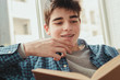 © carballo - young teenage boy reading or studying at home
