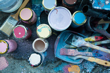 Close Up Of Colorful Bunch Of Brushes And Paint On Floor With Color Stains Outdoor, Used To Make Urban Art Or Diy Painting Decorations