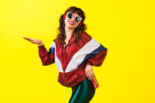 Cheerful Gorgeous Girl In Clothes In The Style Of The 90s, With A Vintage Cassette Player And Headphones, In The Studio On A White Background. Music, Emotions, Fashion
