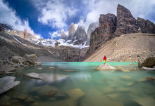 Hiker In Red Jacket Admiring 3 Peaks At Base De Las Torres Viewpoint In Torres Del Paine, Patagonia