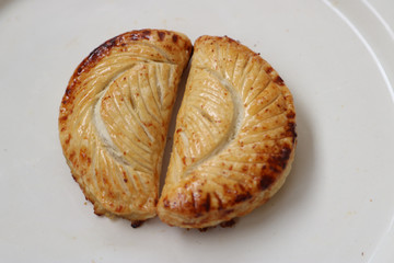 two apple turnovers on white background