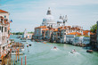 Venice, Italy. Daily boat and tourist hectic on Grand Canal and Basilica Santa Maria della Salute
