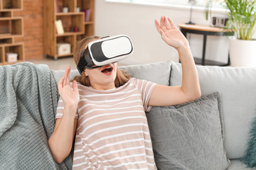 Young woman with VR glasses at home