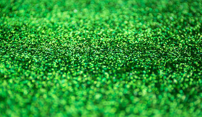 Wall Mural - Blur green sparkle background. Defocused glitter texture.