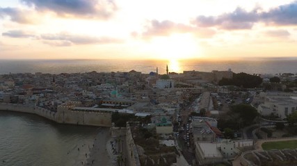 Wall Mural - Aerial summer sunset fly over of Acco, Acre, Akko medieval old city with green roof Al Jazzar mosque and crusader palace, city walls, arab market,  knights hall, crusader tunnels,  in Israel