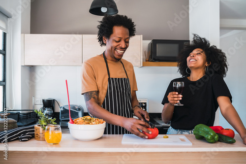 Fotografía Afro couple cooking together in the kitchen.