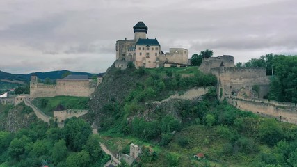 Wall Mural - Slow descending aerial flight showing  Medieval Trencin castle in Slovakia Europe with concentric walls, towers, barbican, keep and moat