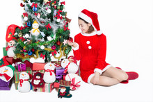 Pretty Girl Sitting By Christmas Tree On White Background,studio Shot.There Has Blank Space For Text.