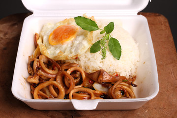 Wall Mural - Rice topped with spicy fried squid, basil leaves and fried egg (Thai food)