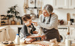 © JenkoAtaman - happy family grandmother and granddaughter child cook in the kitchen, knead dough, bake cookies