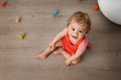 © Lisa Tichané - Cute baby sitting on floor playing with alphabet blocks