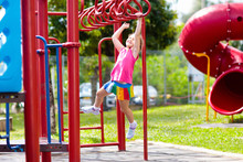 Child On Monkey Bars. Kid At School Playground.