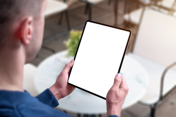 Poster - Tablet mockup in man hands in coffee shop. View over guy shoulder