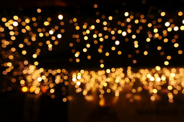 background of abstract glitter lights. gold and black. de focused