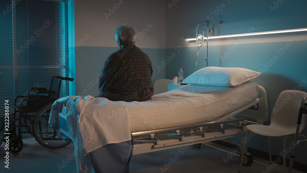 Depressed senior sitting on the hospital bed alone - obrazy, fototapety, plakaty 