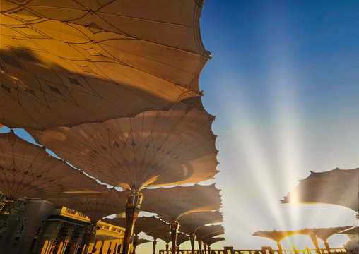 Medina, Saudi Arabia - August 25, 2019: Sunrise or golden hour view during haze weather at Nabawi Mosque or Prophet Mosque in Medina, Saudi Arabia.